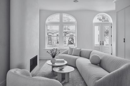 an off white living room in a minimalist style with white walls and a warm white sofa