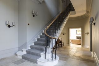 Staircase wall lighting in a traditional hallway