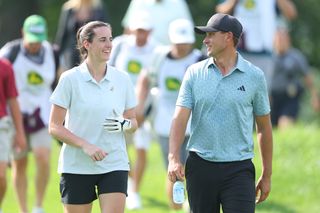 Caitlin Clark and Ludvig Aberg walking down a fairway chatting