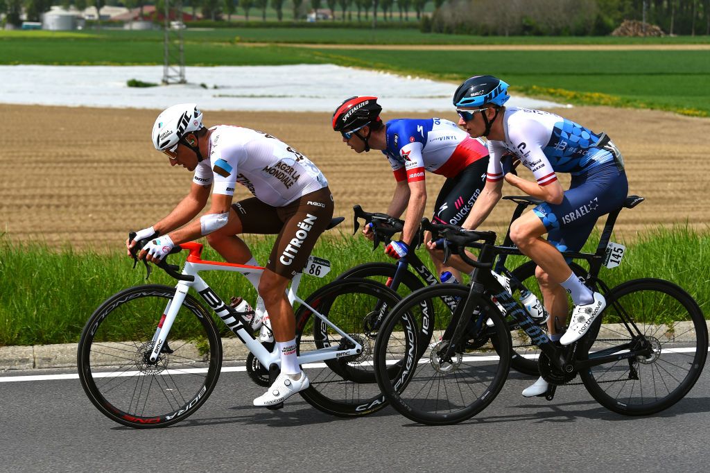 VALBROYE SWITZERLAND APRIL 29 LR Nans Peters of France and AG2R Citroen Team Rmi Cavagna of France and Team QuickStep Alpha Vinyl and Krists Neilands of Latvia and Team Israel Premier Tech compete in the breakaway during the 75th Tour De Romandie 2022 Stage 3 a 1651km stage from Valbroye to Valbroye TDR2022 on April 29 2022 in Valbroyeon Switzerland Photo by Dario BelingheriGetty Images