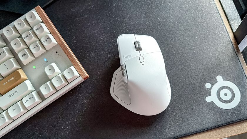 Logitech MX Master 4 mouse on mouse pad next to keyboard