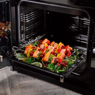 Quad Oven with Proflex Splitter showing salmon and vegetable kebabs being put in the oven ready to cook