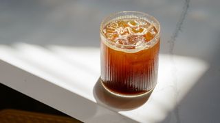 Cold brew in a glass with ice on a shelf