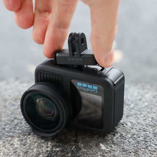 GoPro Magnetic Latch Mount being attached by a hand to a GoPro Hero13 Black action camera