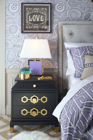 lavender bedroom with lavender wallpaper and bedding