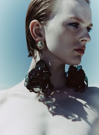Woman in sun with earrings