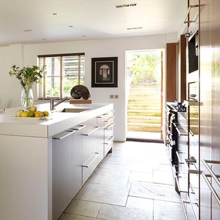 soft grey kitchen with limestone tiles and vase