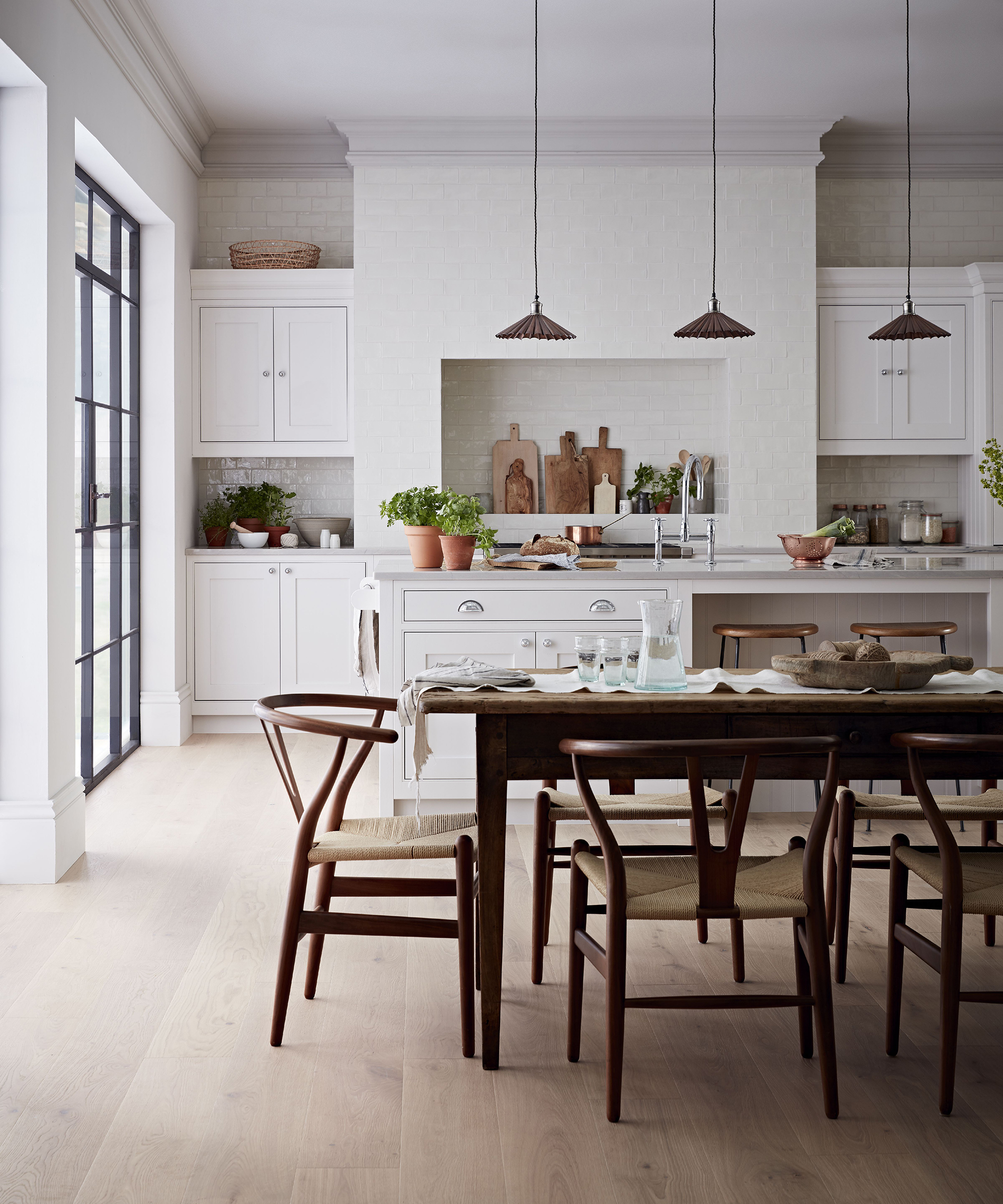 A kitchen lighting idea by Kitchen makers with concertinaed suspended ceiling lights near alcove