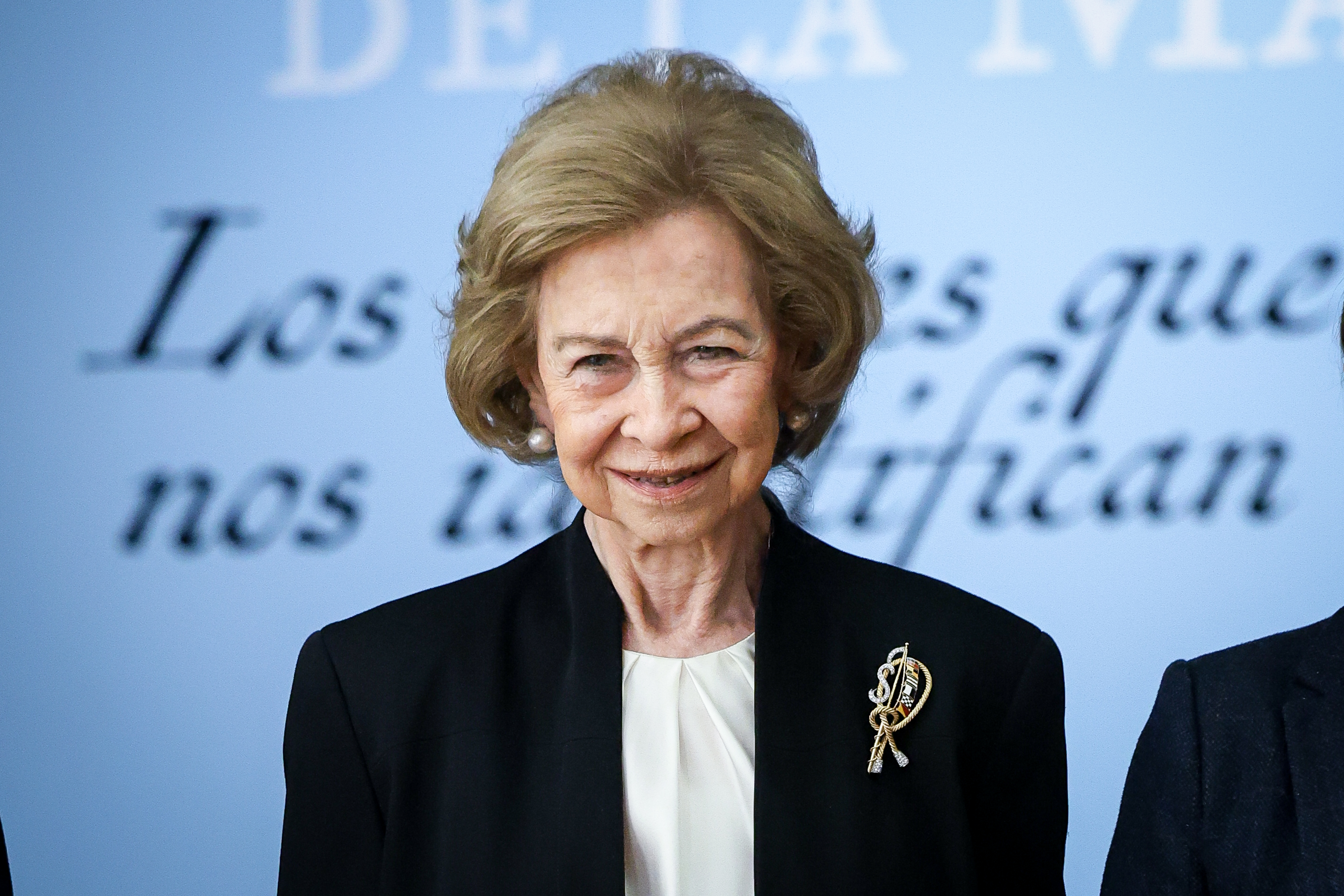 Queen Sofia wearing a black blazer and brooch