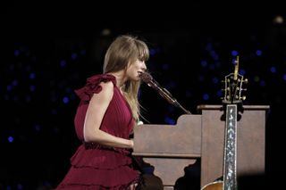 Taylor Swift sings behind a piano