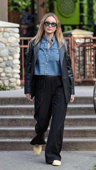 Jennifer Lawerence wearing a leather blazer with a denim top and trousers