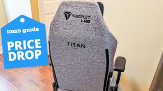 A Secretlab Titan Evo chair in a hallway with a Tom's Guide Price Drop deals badge on top