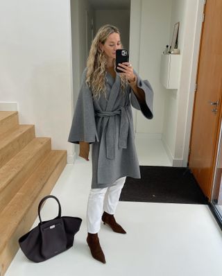 Easy winter outfits: @anoukyve wears a wrap coat with white jeans and suede boots