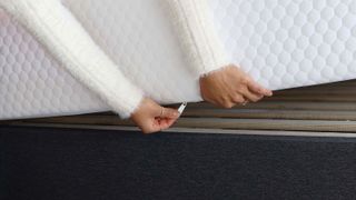 Person unzipping the Layla Essential mattress cover