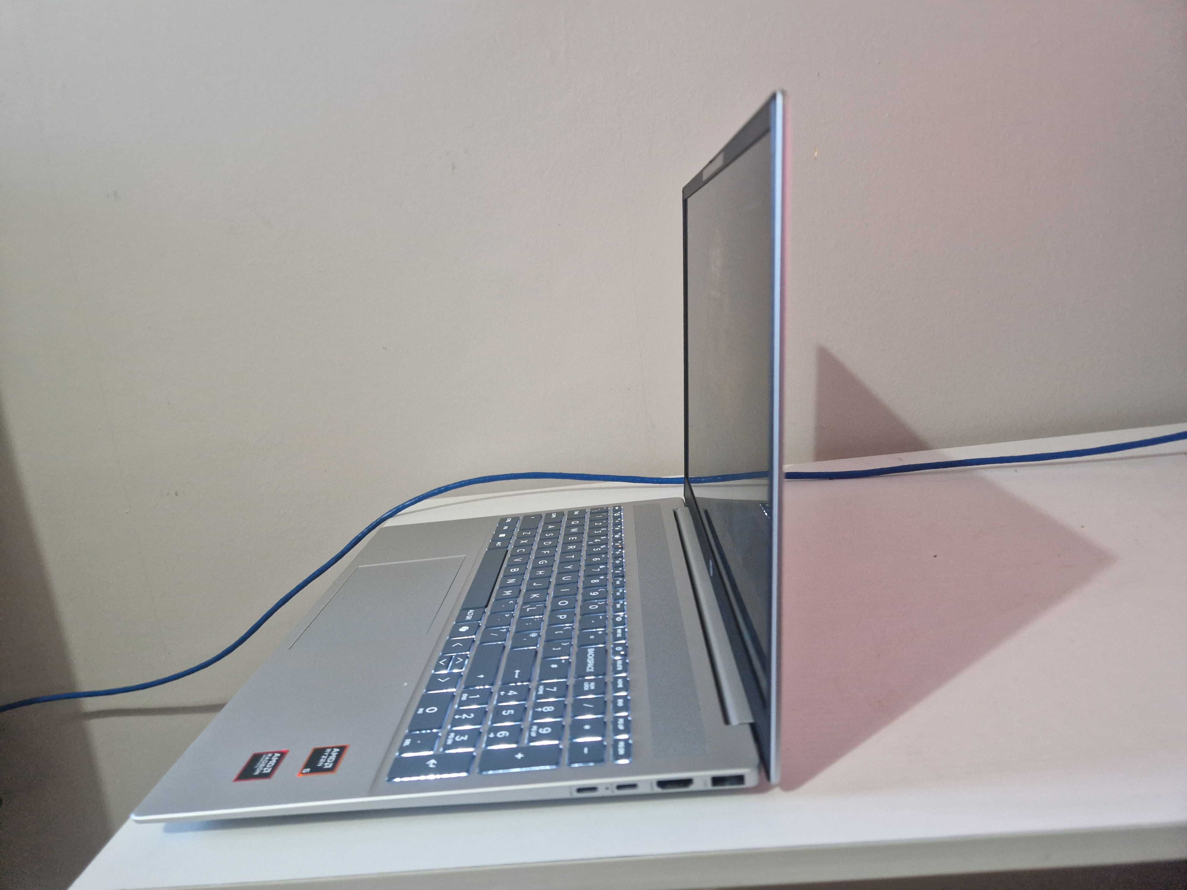 A silver HP Pavilion 16 sitting on a white desk