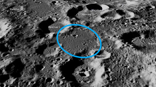 a close up image of the moon from orbit with a circle around a landing site