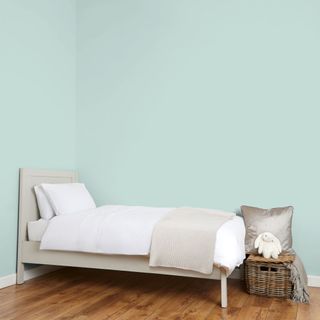 bedroom with duck egg colour wall and wooden floor