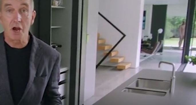 Kevin McCloud still talking but the camera starts zooming in on the statue