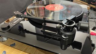 Dual CS 618Q turntable from side slight top angle showing controls, tone arm and black vinyl