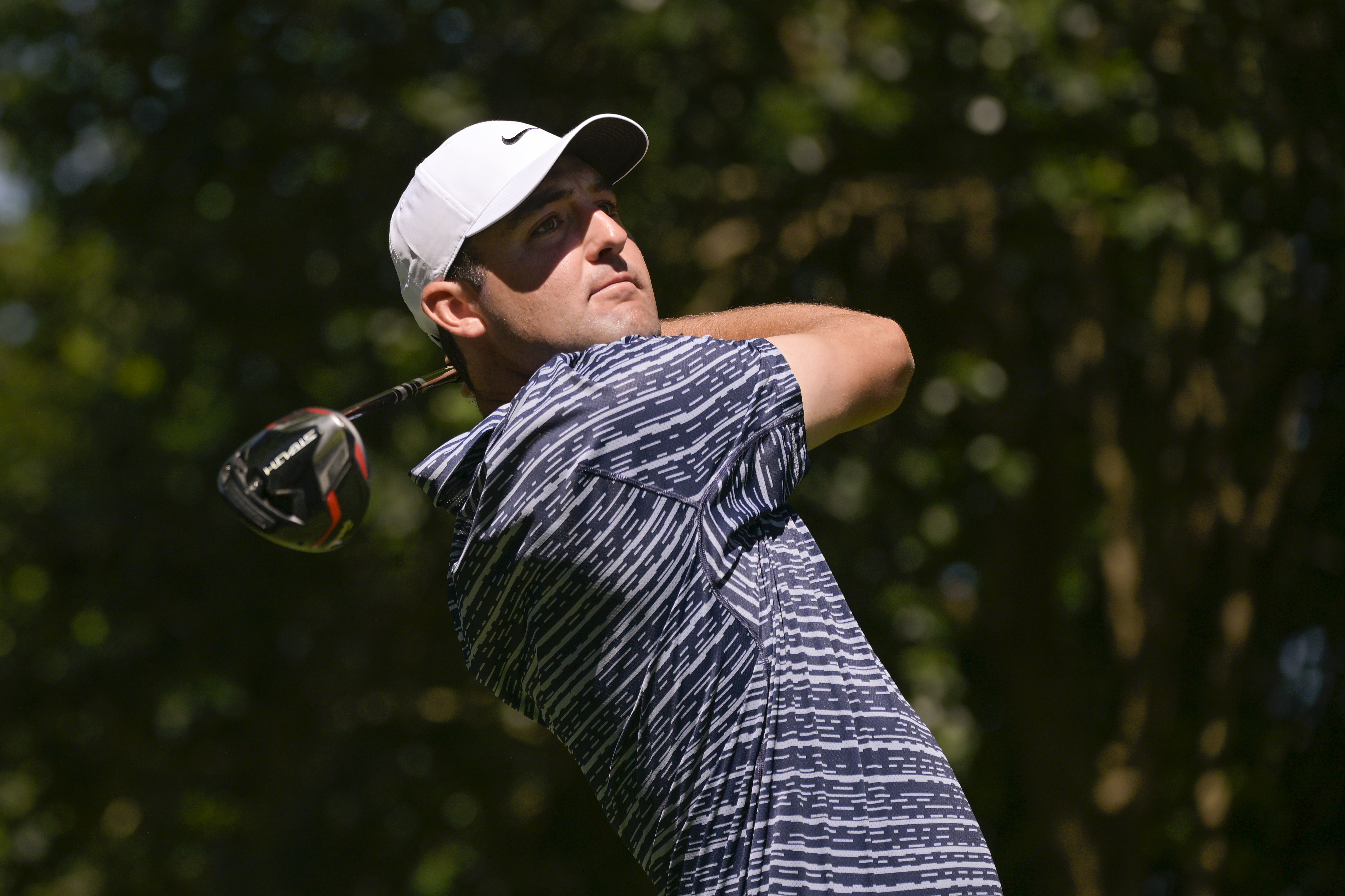 Scottie Scheffler hits a driver