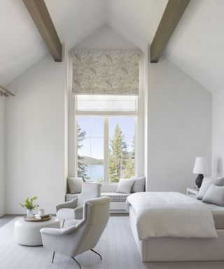 all cream/white bedroom with beams and high ceilings