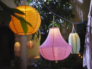 paper garden lanterns lit up at night
