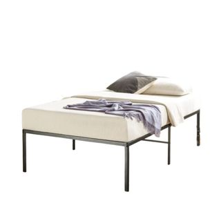 A black steel bed with a white mattress, a throw, and pillows on it