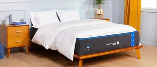 The Nectar Memory Foam mattress on a wooden bed frame in a light and airy bedroom