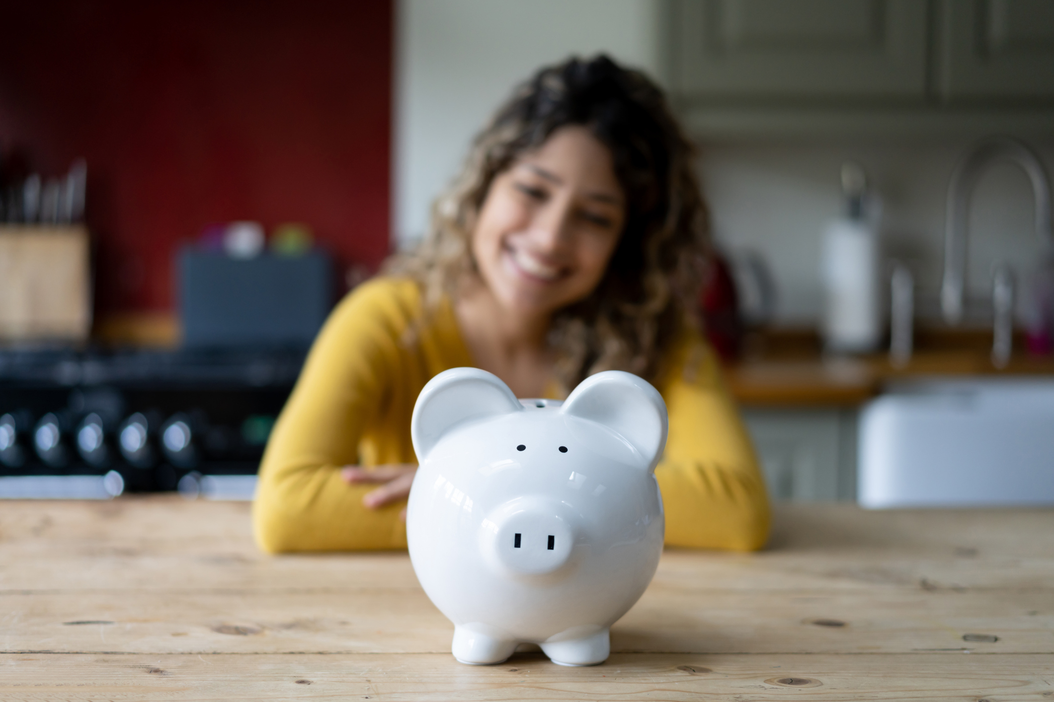 Person looking at piggy bank