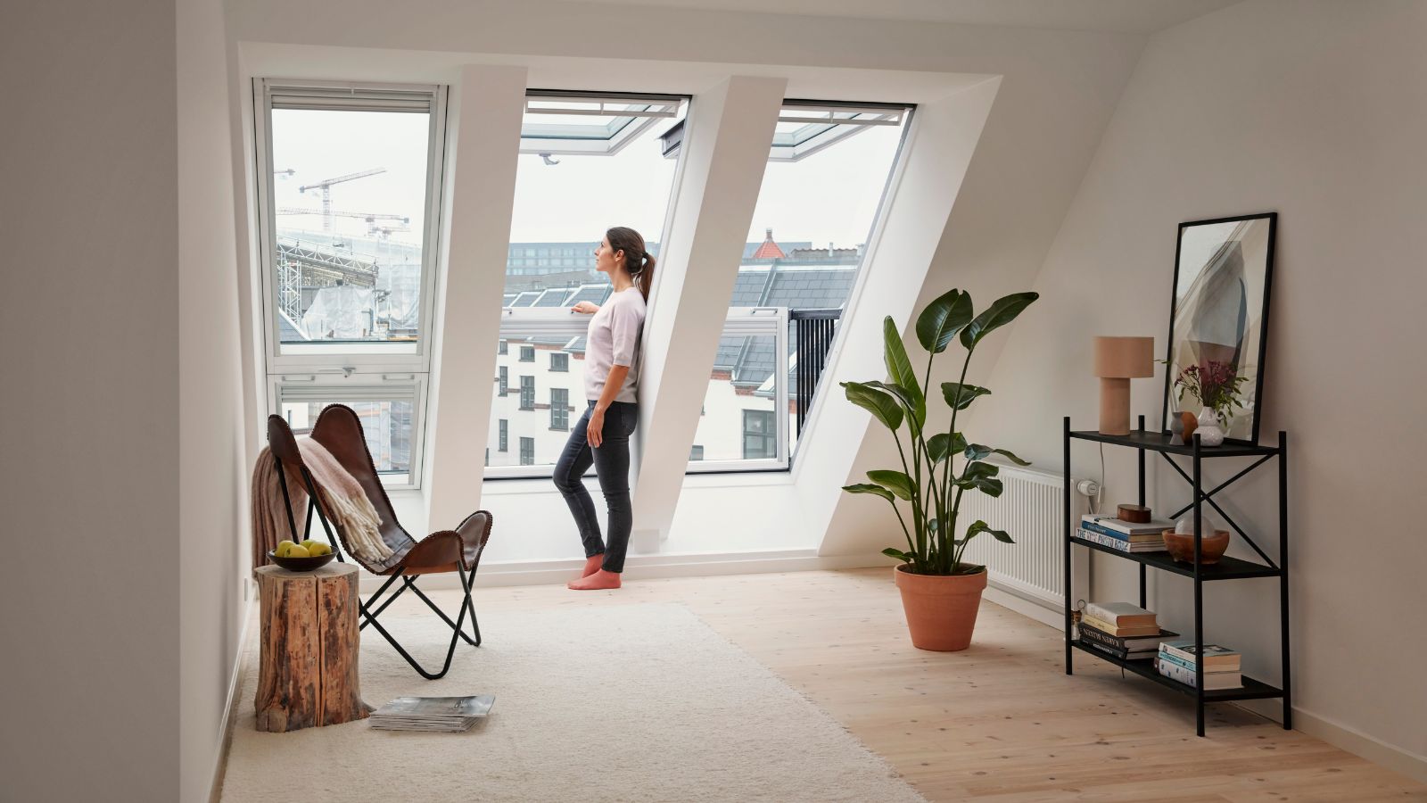 A VELUX Cabrio balcony window that opens up to create a mini rooftop balcony, bringing in natural light and urban views 