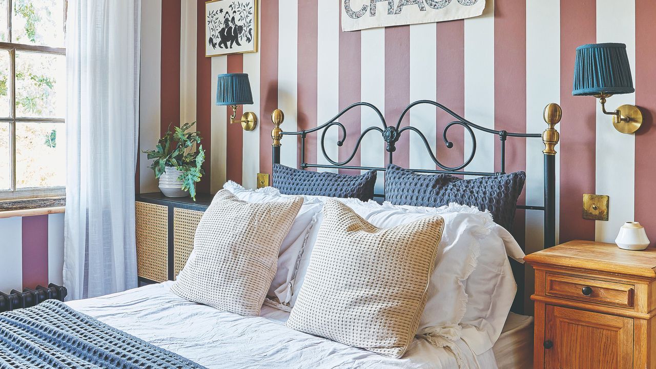 A bedroom with a striped wallpaper