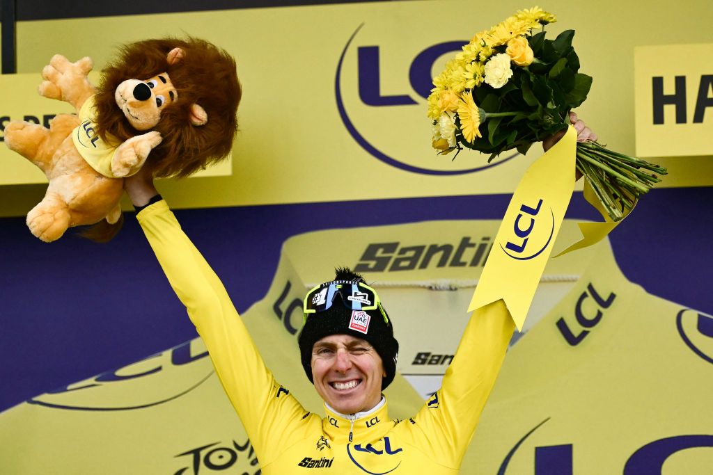 UAE Team Emirates team's Slovenian rider Tadej Pogacar celebrates on the podium with the overall leader's yellow jersey after the 8th stage of the 111th edition of the Tour de France cycling race, 183,5 km between Semur-en-Auxois and Colombey-les-deux-Eglises, on July 6, 2024. (Photo by Marco BERTORELLO / AFP)