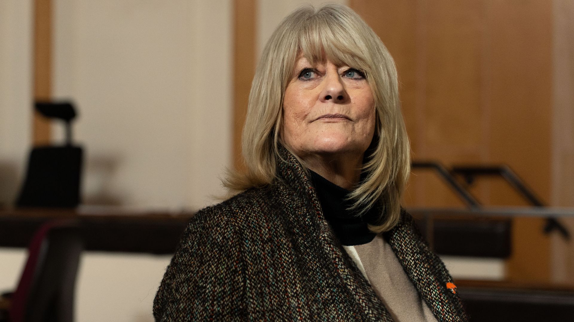 Christine Flack looks at something offscreen