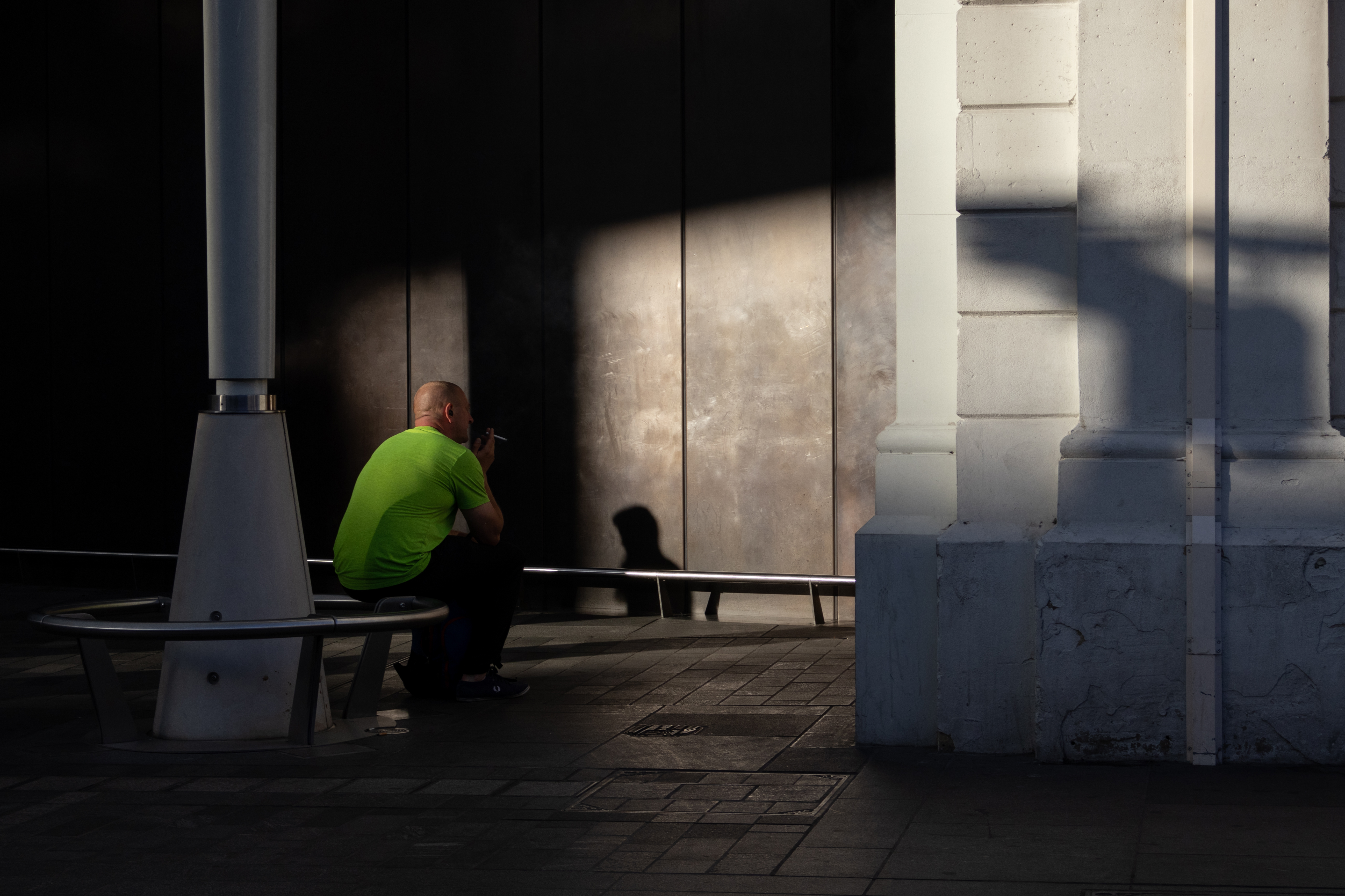 A man sitting outside a train station