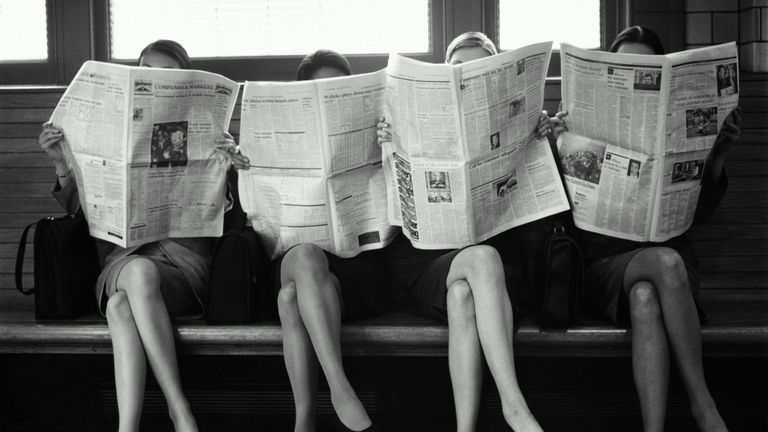 women reading newspaper