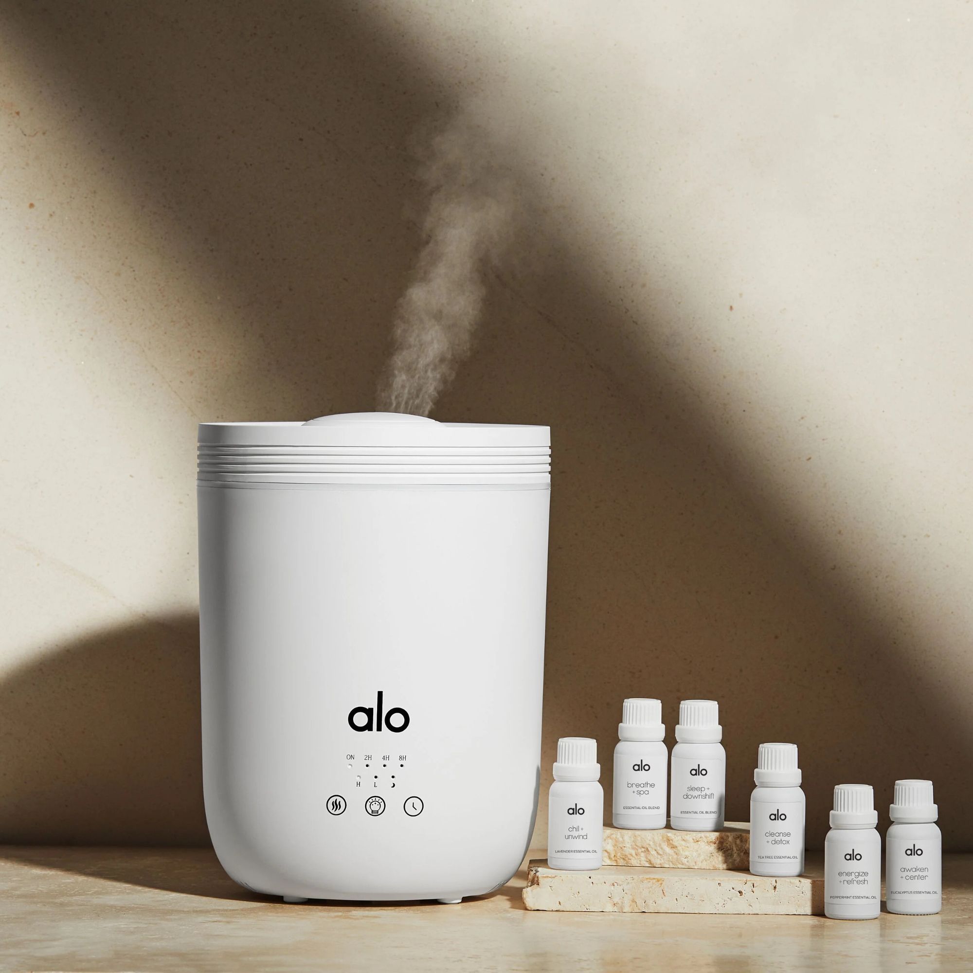 Alo Aura Diffuser against a beige background.