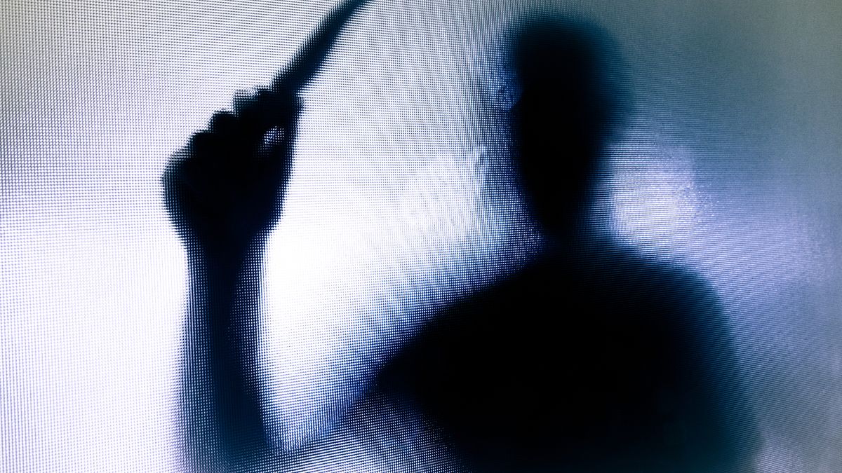 A threatening silhouette opf a man with a knife