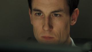 Tobias Menzies studying a display intently in Casino Royale.