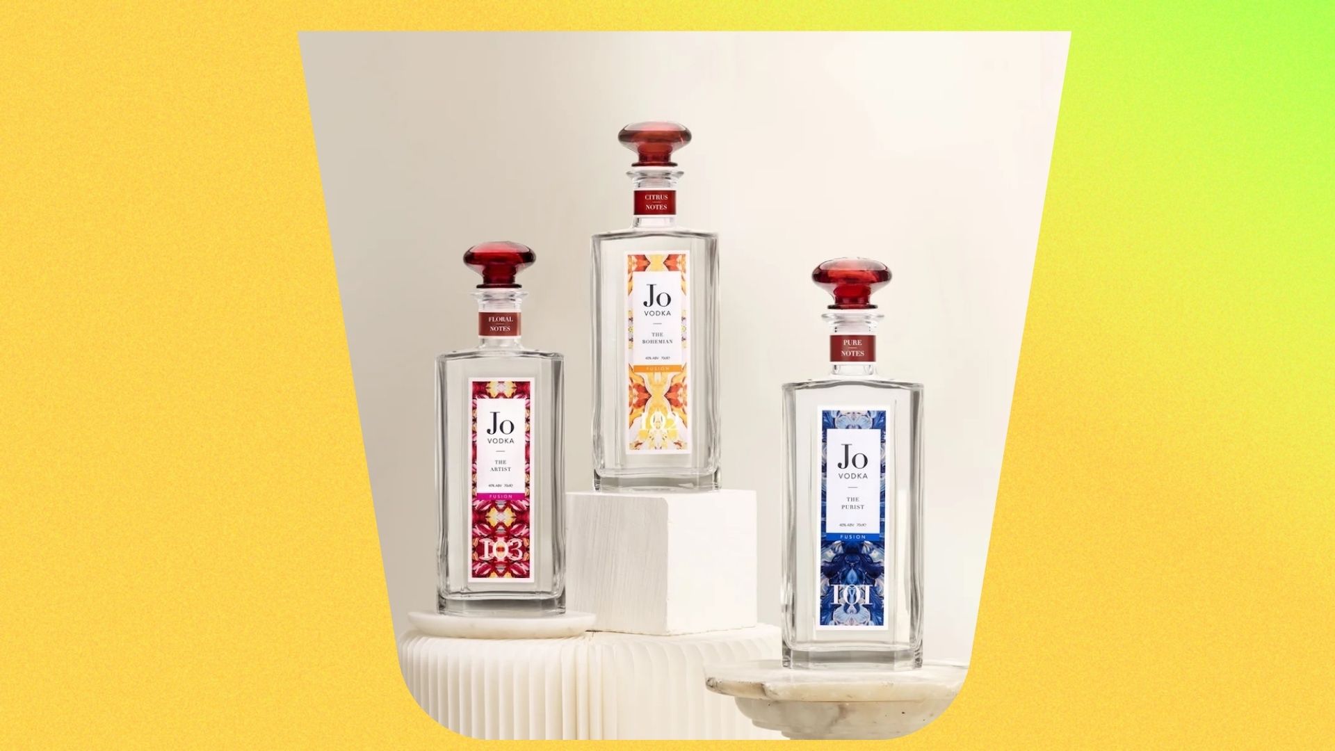 All three of the newly released Jo Vodka range in clear bottles, standing on marble platforms inside a silhouette of a glass 