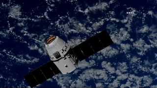 A SpaceX Dragon cargo ship approaches the International Space Station to delivery nearly 3 tons of supplies on July 2, 2018 in this view from a station camera. It is the Dragon's second trip to the space station.