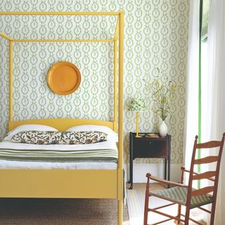 Bedroom with a yellow bed and floral wallpaper
