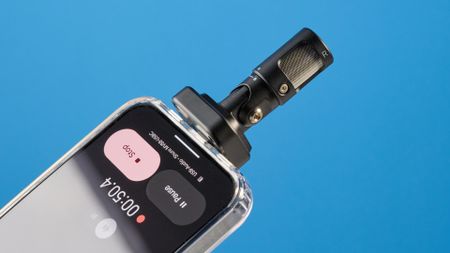 the shure mv88 usb-c microphone photographed against a blue tom's guide background and shown connected to a google pixel 10 pro