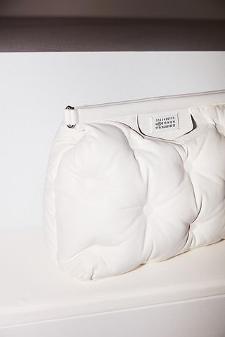 White handbag resembling a cushion