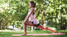 Woman doing yoga for runners in outdoor setting
