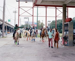 Claiborne Ave 2016 by Akasha Rabut - people on horseback at filling station