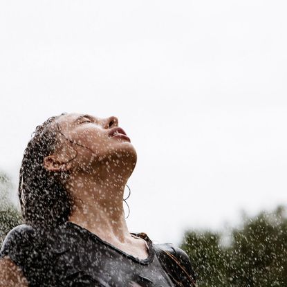 A young woman standing in the rain