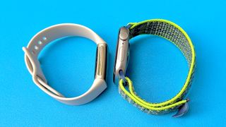 Close-up of the Fitbit Charge 5 next to the Apple Watch Series 11