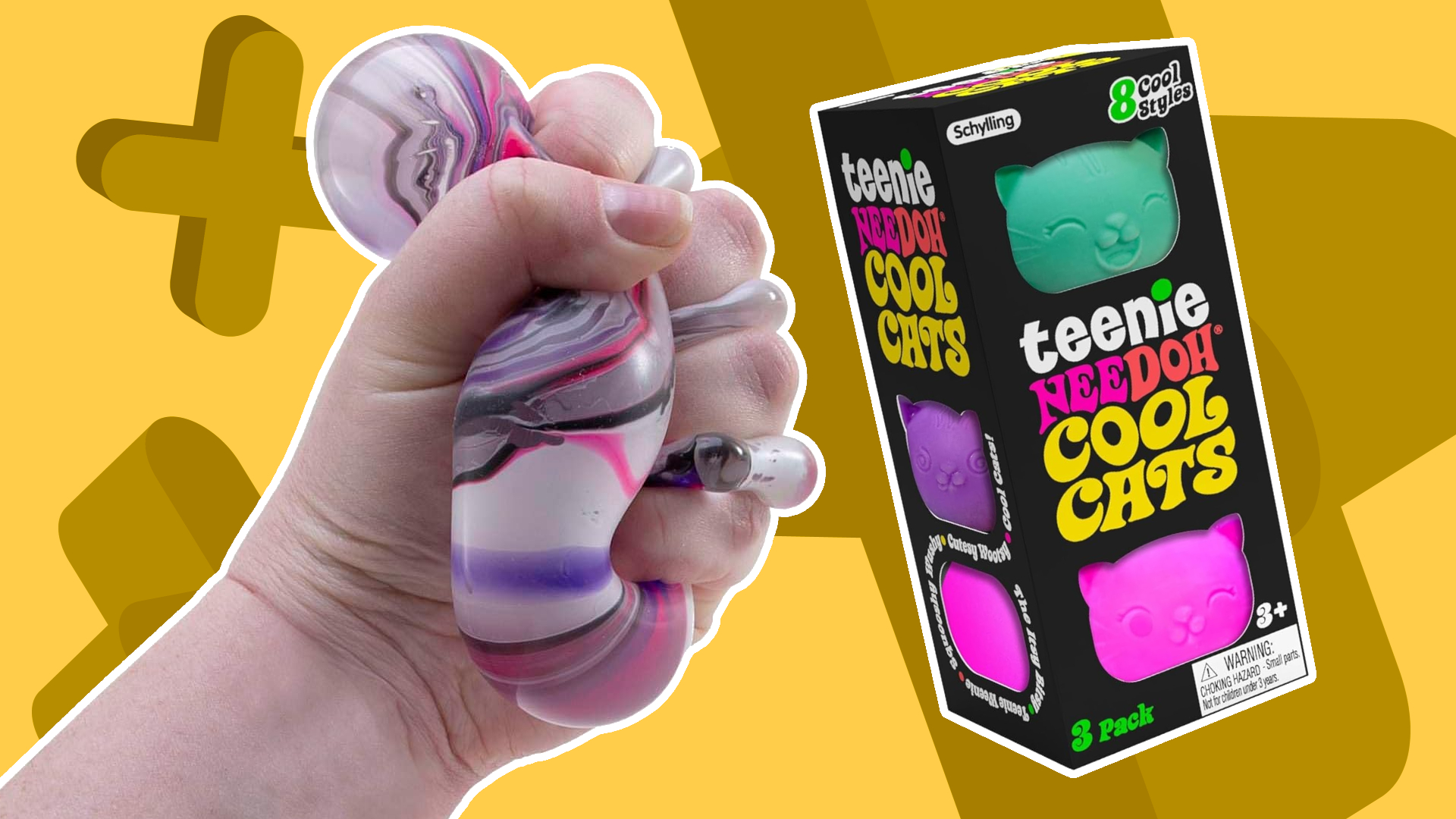 A hand squeezing NeeDoh beside a box of Cool Cats