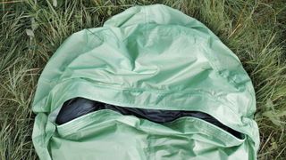 Alpkit Kloke bivy bag lying on grass