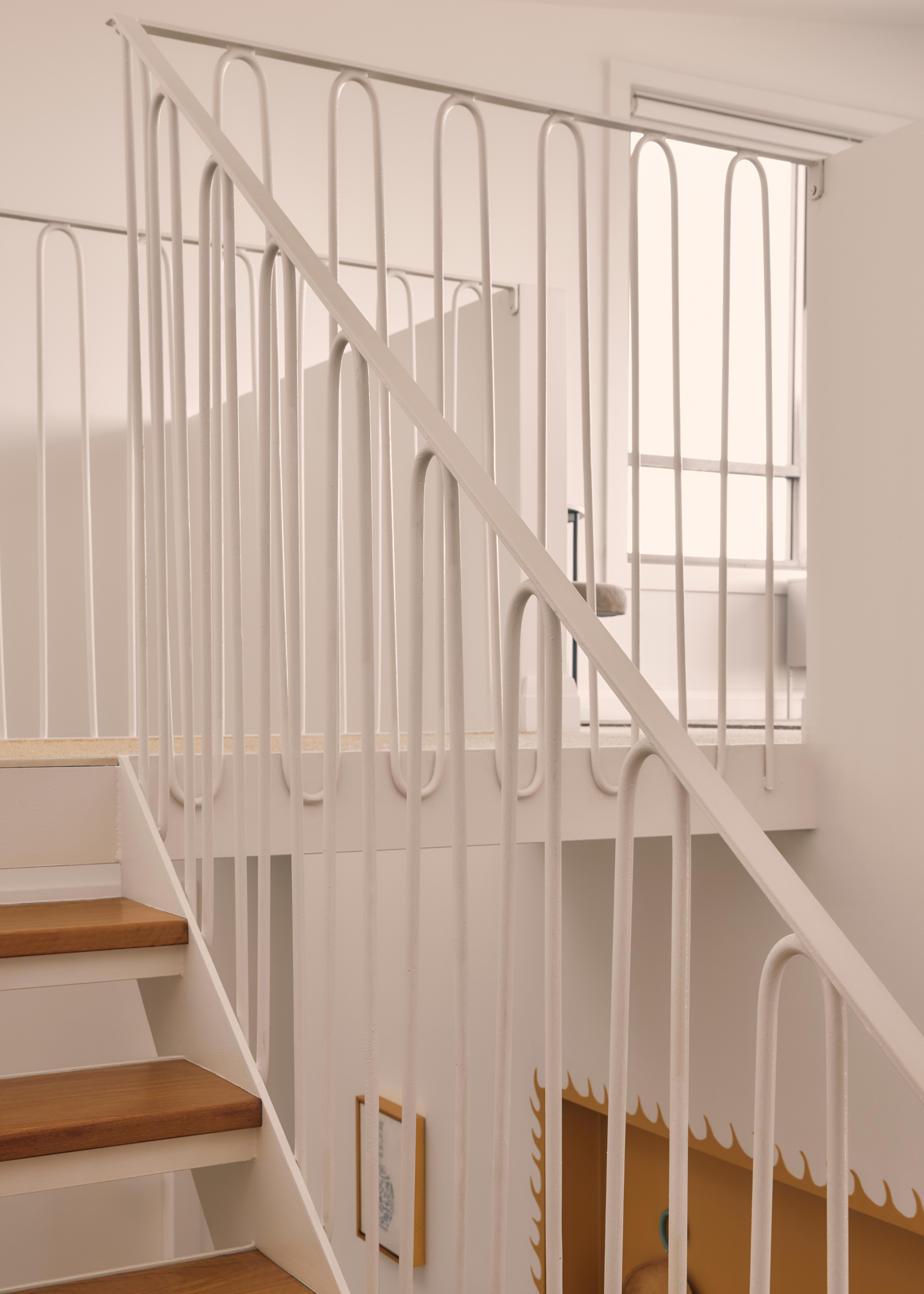 a thin, minimalist white metal railing in a modern beach home